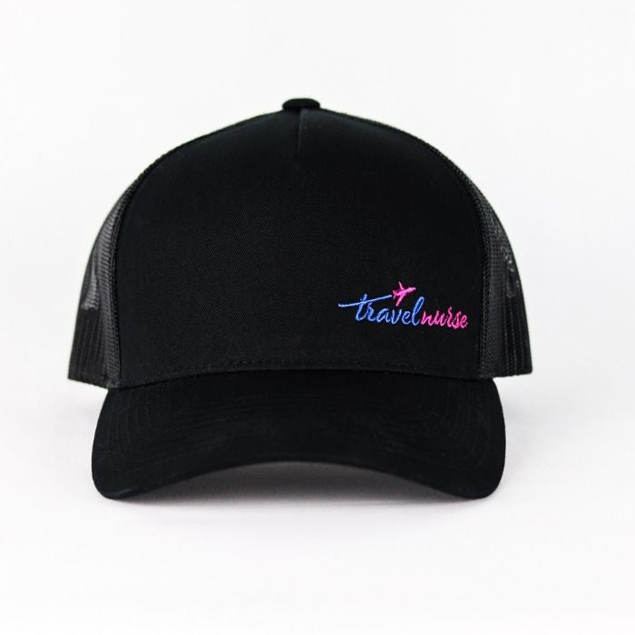 Product photo showing a black mesh back hat with a pink and blue travel nurse logo